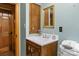 Cozy bathroom featuring a vanity with sink, wooden cabinets, mirror and a toilet with fresh towels at 536 Brookhaven Rd, Statesville, NC 28625