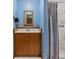 Cozy bathroom with blue walls, a wooden vanity, and a shower with marble-style tiles at 536 Brookhaven Rd, Statesville, NC 28625