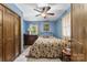 Comfortable bedroom features a ceiling fan, wooden furniture, and natural light from the window at 536 Brookhaven Rd, Statesville, NC 28625