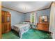 Comfortable bedroom featuring wood trim, soft green carpet, and natural light at 536 Brookhaven Rd, Statesville, NC 28625