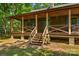 Inviting covered front porch with wooden railings, stairs, and space for seating to enjoy the view at 536 Brookhaven Rd, Statesville, NC 28625