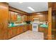 Functional kitchen with wood cabinets, bright countertops, and essential appliances, perfect for everyday cooking at 536 Brookhaven Rd, Statesville, NC 28625