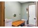 Functional mud room with a utility sink, table, and a door leading to the outside at 536 Brookhaven Rd, Statesville, NC 28625