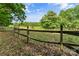 An outdoor paddock with sturdy wooden fencing creates a safe space for animals or livestock to graze and roam at 536 Brookhaven Rd, Statesville, NC 28625