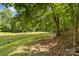 Picture showing the lush green pasture with a sturdy wooden fence, ideal for livestock at 536 Brookhaven Rd, Statesville, NC 28625