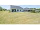 Large, grassy backyard with a covered patio, perfect for outdoor activities and relaxation at 5727 Lavaux Ct, Charlotte, NC 28214