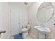 Clean half-bathroom has a pedestal sink, a tile floor, and a bright white color scheme at 5727 Lavaux Ct, Charlotte, NC 28214