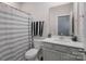 Cozy bathroom featuring a shower with striped curtain, toilet, and modern vanity at 5727 Lavaux Ct, Charlotte, NC 28214