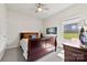 Comfortable bedroom with wood furnishings, a ceiling fan, and a window with natural light at 5727 Lavaux Ct, Charlotte, NC 28214