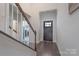 Bright foyer with hardwood floors, stairs, and front door at 5727 Lavaux Ct, Charlotte, NC 28214
