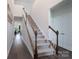 Bright foyer with hardwood floors, staircase, and natural light at 5727 Lavaux Ct, Charlotte, NC 28214