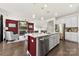 Open-concept kitchen with an island, modern appliances, granite countertops, and dark wood floors at 5727 Lavaux Ct, Charlotte, NC 28214