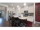 Stylish kitchen island with seating, pendant lighting, and stainless steel appliances at 5727 Lavaux Ct, Charlotte, NC 28214