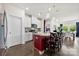 Bright kitchen with white cabinets, granite countertops, pendant lighting, and a red accent wall at 5727 Lavaux Ct, Charlotte, NC 28214