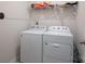 Bright laundry room featuring a white washer and dryer with a storage shelf above at 5727 Lavaux Ct, Charlotte, NC 28214