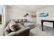 Comfortable living room featuring a sectional sofa, ottoman and decoratively adorned walls at 5727 Lavaux Ct, Charlotte, NC 28214