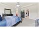 Well-lit main bedroom features neutral carpet, tray ceiling, and a view to an attached bathroom and walk-in closet at 5727 Lavaux Ct, Charlotte, NC 28214