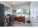 Bright office with large windows, neutral walls, desk and neutral carpet at 5727 Lavaux Ct, Charlotte, NC 28214