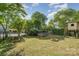 Backyard featuring bricked fire pit, trampoline, and a tree house, great for Gathering gatherings at 6040 Morris Farm Ln, Mint Hill, NC 28227