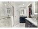 Well lit bathroom with marble floors, shower, and a large vanity with storage at 6040 Morris Farm Ln, Mint Hill, NC 28227
