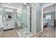 Modern bathroom with glass shower, white vanity, and light blue walls at 6040 Morris Farm Ln, Mint Hill, NC 28227
