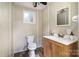Cozy bathroom featuring wood-like plank walls, vanity with a solid countertop and a window at 6040 Morris Farm Ln, Mint Hill, NC 28227