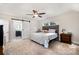 Bright bedroom with a barn door, a ceiling fan and ensuite bathroom entrance at 6040 Morris Farm Ln, Mint Hill, NC 28227