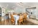 Charming dining room with wood table, bright lighting and views into the kitchen and staircase at 6040 Morris Farm Ln, Mint Hill, NC 28227