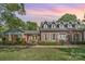 Charming brick home featuring dormer windows and well-maintained landscaping for inviting curb appeal at 6040 Morris Farm Ln, Mint Hill, NC 28227
