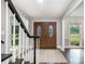 Elegant foyer with hardwood floors, a staircase, and a view of the outdoors at 6040 Morris Farm Ln, Mint Hill, NC 28227