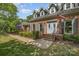 Inviting front entrance of a brick home with a landscaped yard and stylish doors at 6040 Morris Farm Ln, Mint Hill, NC 28227
