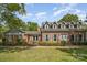 Beautiful brick home featuring dormer windows and well-maintained landscaping for inviting curb appeal at 6040 Morris Farm Ln, Mint Hill, NC 28227