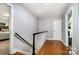 Hallway with hardwood floors and a staircase leading to an upper level at 6040 Morris Farm Ln, Mint Hill, NC 28227