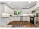 Bright kitchen with stainless steel appliances, undermount lighting and white cabinets at 6040 Morris Farm Ln, Mint Hill, NC 28227