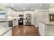 Spacious kitchen with stainless steel appliances, white cabinets, and hardwood flooring at 6040 Morris Farm Ln, Mint Hill, NC 28227