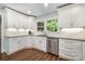 Well lit kitchen featuring stainless steel dishwasher, white cabinets and tiled backsplash at 6040 Morris Farm Ln, Mint Hill, NC 28227