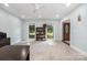 Bright living room features a ceiling fan, carpet, and two windows that offers plenty of natural light at 6040 Morris Farm Ln, Mint Hill, NC 28227