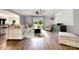 Spacious living room with wood floors, large sectional, ceiling fan and sliding door to the backyard at 6040 Morris Farm Ln, Mint Hill, NC 28227