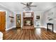 Cozy living room features brick fireplace, wood flooring and a view of the pool at 6040 Morris Farm Ln, Mint Hill, NC 28227