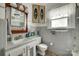 Bathroom featuring tiled walls, tiled countertops, a sink, a toilet and a large mirror at 622 Neelys Creek Rd, Rock Hill, SC 29732