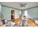 Bedroom with hardwood floors, light blue walls, a ceiling fan and white trim, with adjoining rooms at 622 Neelys Creek Rd, Rock Hill, SC 29732