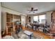 A spacious living room with hardwood floors, a ceiling fan, natural light, and built in bookcases at 622 Neelys Creek Rd, Rock Hill, SC 29732
