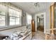 Sun Room featuring tiled floor, a ceiling fan, a bright window with white trim and curtains, and access to another room at 622 Neelys Creek Rd, Rock Hill, SC 29732