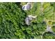 An aerial view of a home nestled in a lush forest, showing proximity to another residence with a pool at 7103 Forest Ridge Rd, Matthews, NC 28104
