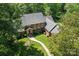 Aerial view of brick home with mature trees, manicured lawn, and walkway at 7103 Forest Ridge Rd, Matthews, NC 28104