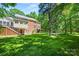 Expansive backyard with mature trees, multilevel deck, and manicured lawn perfect for outdoor activities at 7103 Forest Ridge Rd, Matthews, NC 28104