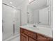 Bright bathroom features single sink vanity and glass shower doors at 7103 Forest Ridge Rd, Matthews, NC 28104