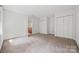 Bright bedroom featuring a neutral carpet and lots of closet space at 7103 Forest Ridge Rd, Matthews, NC 28104