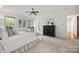 Bright bedroom boasts natural light, neutral colors, and ceiling fan at 7103 Forest Ridge Rd, Matthews, NC 28104