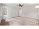 Spacious bedroom featuring neutral carpet, a ceiling fan, and white trim at 7103 Forest Ridge Rd, Matthews, NC 28104